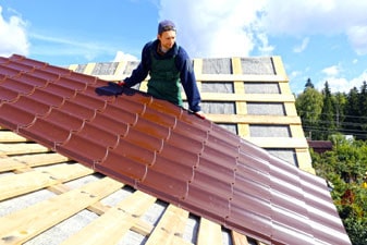 roofer installing metal roof