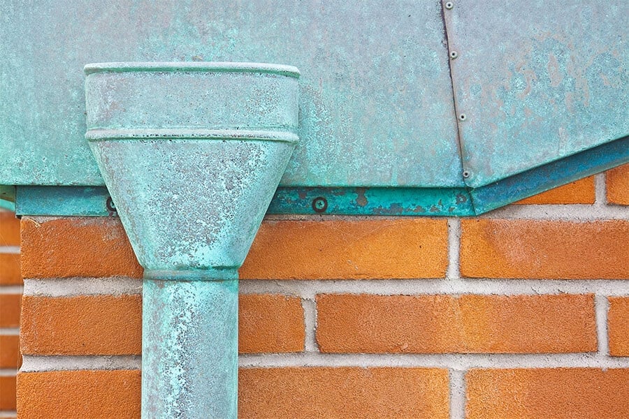 aged copper leaderhead and copper flashing with natural patina finish